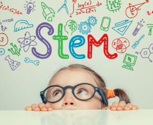 STEM-Wort und Symbole über einem schönen, niedlichen kleinen Mädchen. Konzept der modernen Bildung.